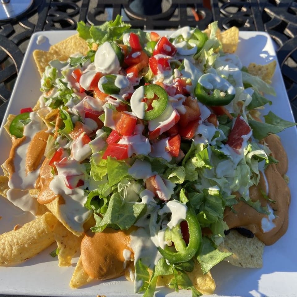 Ultimate Cheese with Our Towering Nachos! 🧀🥑🌶️✨